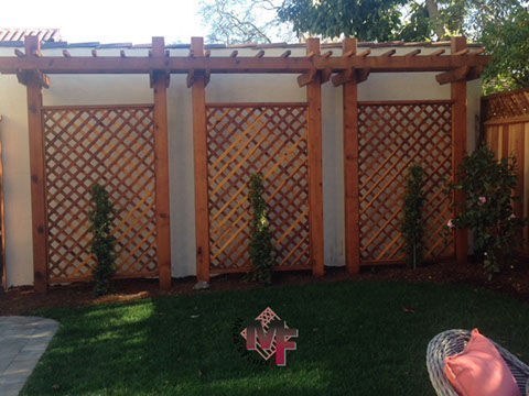 Redwood deck with arbor by Meza's Fence